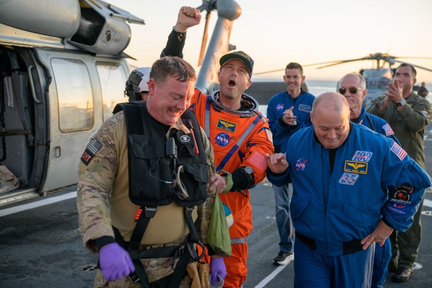 NASA astronaut Reid Wiseman, Artemis II commander is assisted off the flight deck after arriving aboard USS John P. Murtha on Friday.