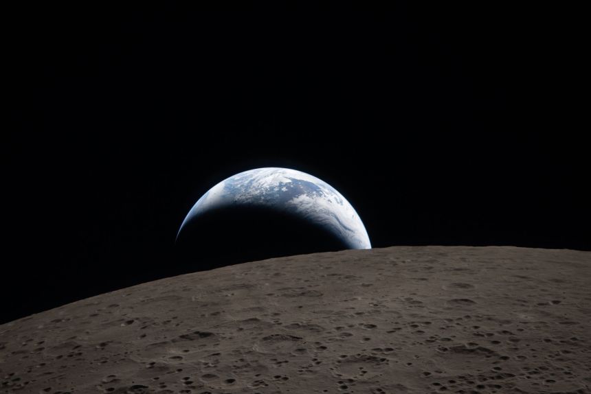 Earth sets behind the moon on April 6, during the lunar flyby of the Artemis II mission.